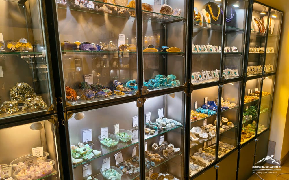 Colorful minerals and gemstones displayed in glass cabinets at a shop window